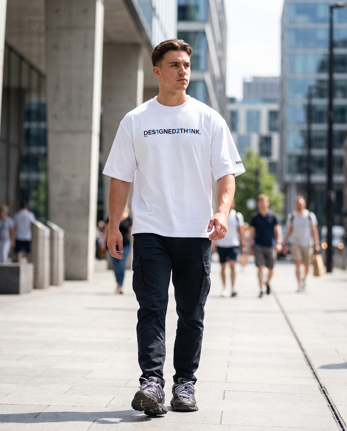 Man wearing Base1 Designed2Think oversized heavyweight t-shirt on a city street