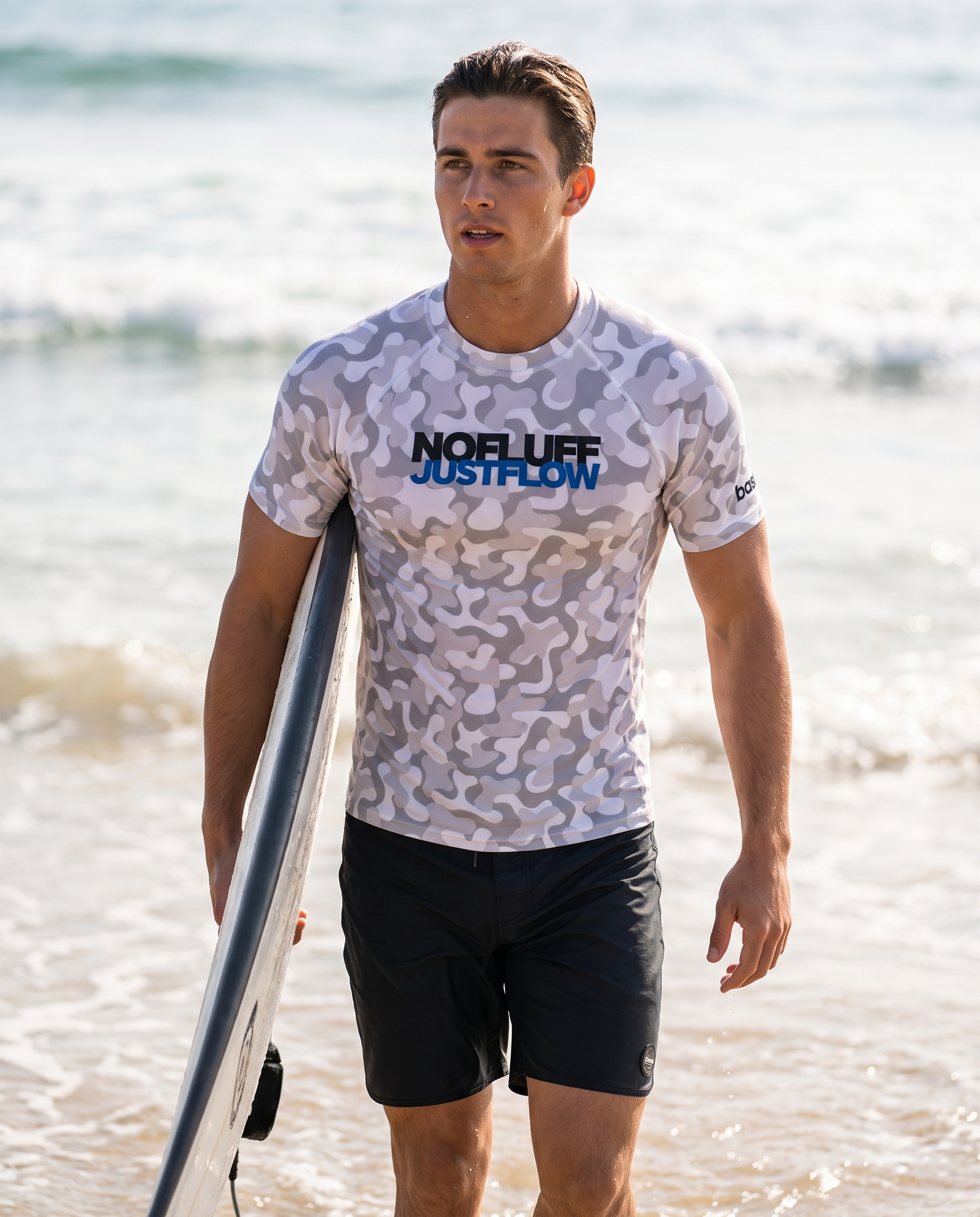 Man wearing Base1 No Fluff Just Flow rash vest on a beach