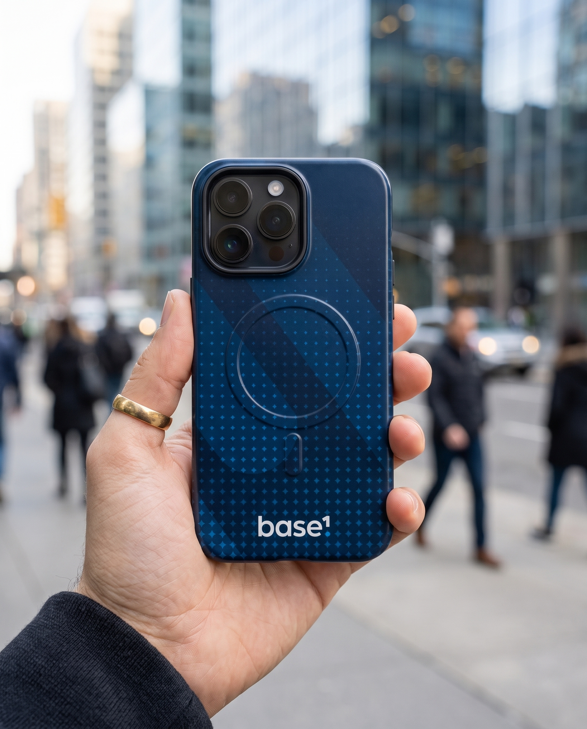 Hand holding iPhone with Base1 Half Tone MagSafe case in the city