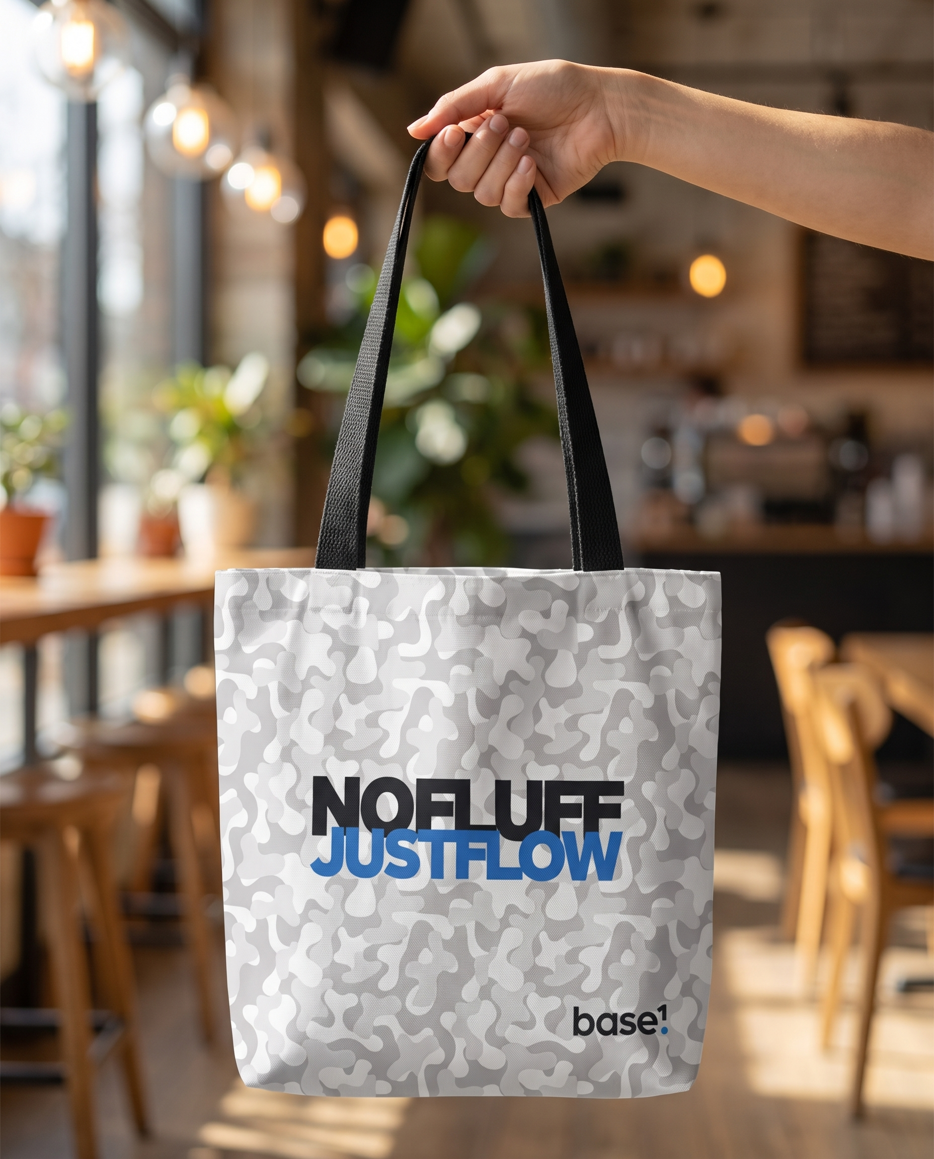 Base1 Just Flow tote bag held in a cafe