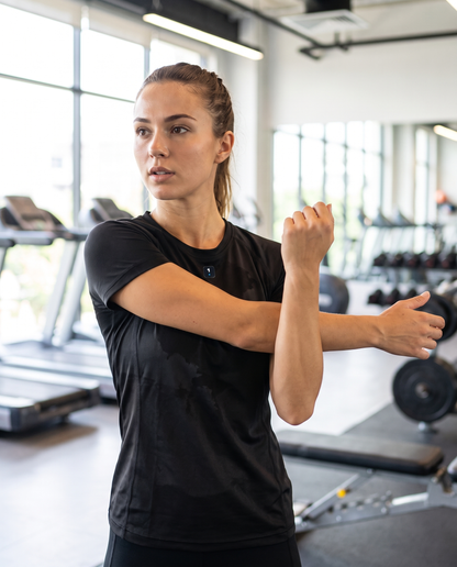 Woman wearing Base1 Active Women's Performance T-Shirt in a gym