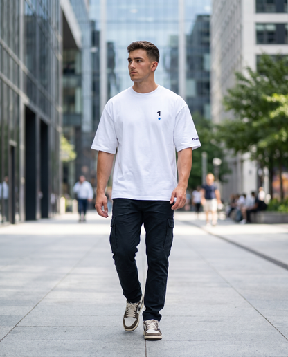 Man wearing Base1 Logo Oversized Heavyweight Tee on a city street