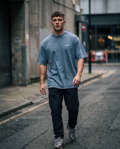 Man wearing Base1 Snow Washed Tee on a city street