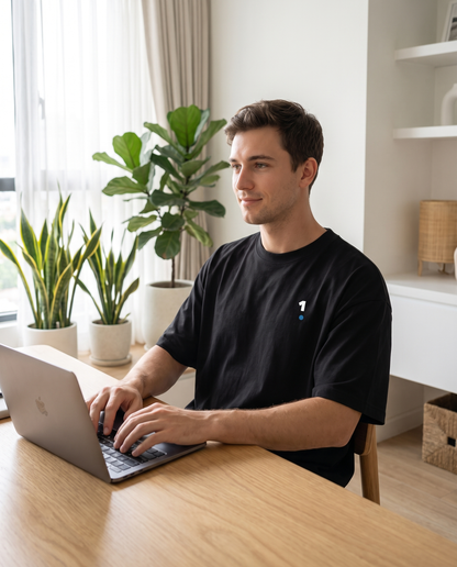 Man wearing Base1 1 Logo Tee Essentials working from home