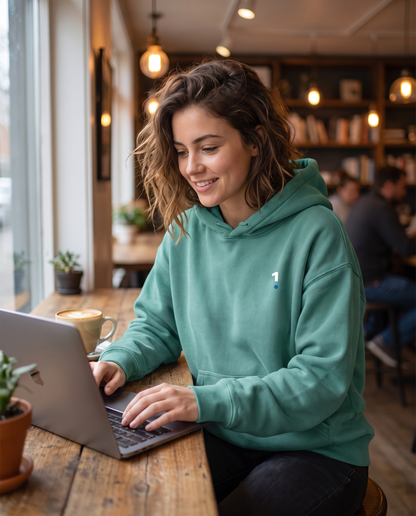 Woman wearing Base1 Oversize Fleeced Hoodie in a cafe
