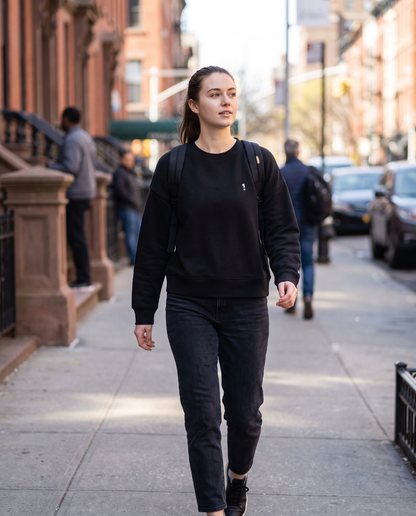 Woman wearing 1 Logo organic crew neck sweatshirt on a city street